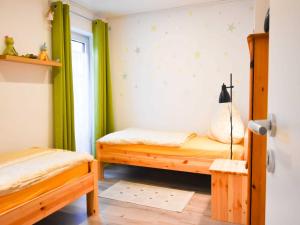 a bedroom with two beds and a window at Ferienhaus Deerberg in Hasselberg
