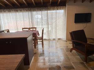 una cucina e una sala da pranzo con tavolo e sedie di Omodos Katoi Holiday Homes a Omodos