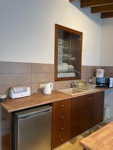 a kitchen with a counter with a sink and a counter at Omodos Katoi Holiday Homes in Omodos