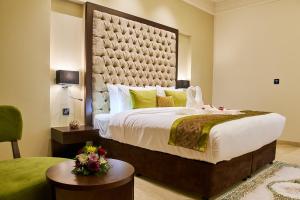 A bed or beds in a room at Carlton Dubai Creek Hotel