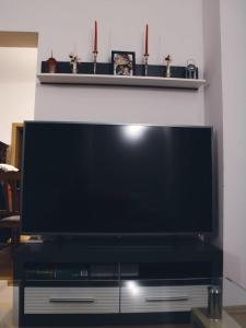 Une grande télévision à écran plat est installée au-dessus d'une table. dans l'établissement APARTMENTS KRAPEC, à Ježdovec