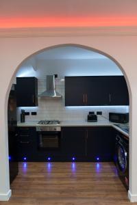 an archway in a kitchen with a stove top oven at Kitchener house in Leeds