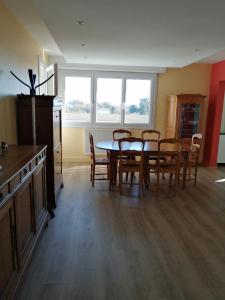 a kitchen and dining room with a table and chairs at Réter in Aytré +5 photos