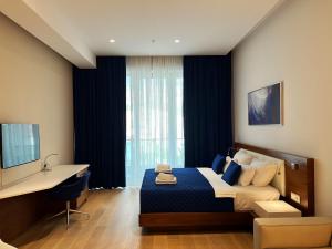 a bedroom with a bed and a desk and a window at Condo Studio Plaza in Budva