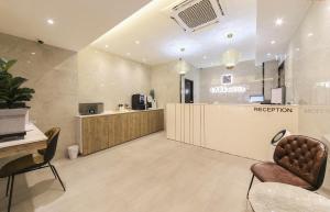 a reception area of a salon with chairs and a counter at LABE Hotel in Jeonju