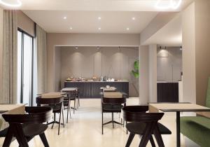 a restaurant with tables and chairs and a bar at Mariette Rhodes Urban Suites in Rhodes Town