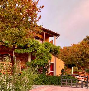 un bâtiment avec un banc devant lui dans l'établissement La Fucinaia Pet Friendly B&B, à Campiglia Marittima