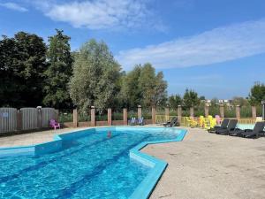 a large swimming pool with blue water in a yard at Buiten aan zee by Droomvilla in Sint Maarten