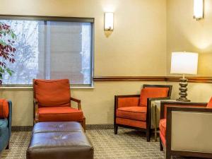 a waiting room with two chairs and a window at Comfort Inn & Suites East Moline near I-80 in East Moline