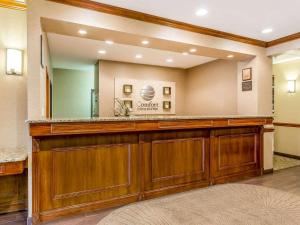 a bar with a large mirror in a room at Comfort Inn & Suites East Moline near I-80 in East Moline