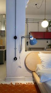 a room with a bed with a table and a lamp at Trilogy Experimental in Thessaloniki
