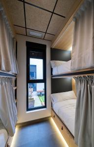 a room with two bunk beds and a window at Dpaso hostel in Chantada