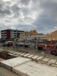 a parking lot in a city with buildings at Hotel le Provençal in Narbonne-Plage