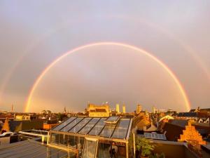 a couple of double rainbow over a city at Great in Ghent
