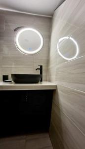 a bathroom with a sink and a round window at Hunting Tower Na Škaluc in Šentrupert