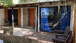 a house with large glass windows and a door at Escape a la Naturaleza in Santa Ana