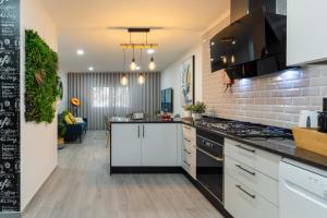 cocina con armarios blancos y encimera en HOME@abrantes, en Abrantes