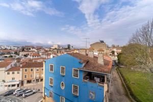 a blue building with a city in the background at HOME@abrantes in Abrantes
