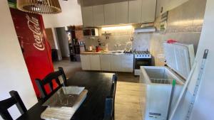 a kitchen with a table and a kitchen with a stove at Escape a la Naturaleza in Santa Ana