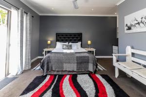 a bedroom with a large bed and a large window at Fish Eagle Manor in East London