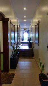 a large room with a walkway leading to a hallway at African Tulip in Arusha