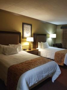 a hotel room with two beds and two lamps at Owen Sound Inn in Owen Sound