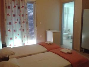 Ένα ή περισσότερα κρεβάτια σε δωμάτιο στο Ξενοδοχείο Ισιδώρα 