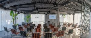 a room with a bunch of chairs in it at Joy 5 Hotel & SPA in Belgrade