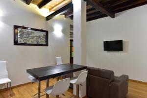 a dining room with a black table and white chairs at Elite Rome apartments 2 in Rome
