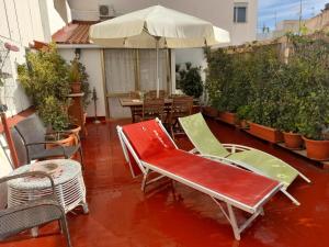 a patio with chairs and a table and an umbrella at La Terraza in Vinaròs