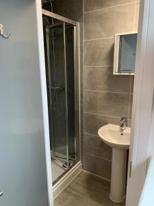 a bathroom with a shower and a sink at Kings Cross by Pureserviced in Plymouth