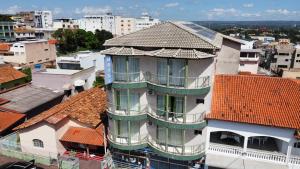 a building with a balcony on top of a city at Hotel Estrela Mares in Três Marias