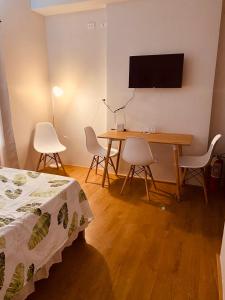 a room with a table and a television on a wall at Mesatierra Garden Residences in Davao City