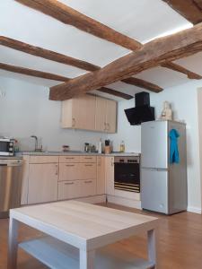 a kitchen with a white refrigerator and a table at Monteurswohnungen in Biedenkopf in Biedenkopf