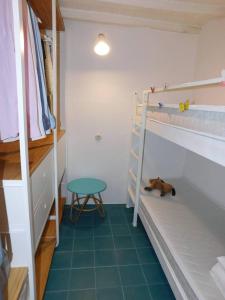 サンタ・マルゲリータ・リグレにあるA Casa di Lettaの二段ベッド2台が備わる客室で、床に犬が1匹寝ています。 +2枚の写真