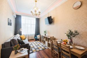 a living room with a couch and a dining room at GMApartments Red Square in Moscow