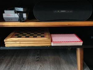 a shelf with a chess board and a microwave at 7B&B in Amsterdam