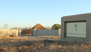 a sign in front of a building with a building at The Wild Olive Tree Camp in Manyeleti Game Reserve