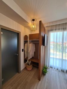 a hallway with a mirror and a closet with a television at Alkion Boutique Living in Nea Vrasna