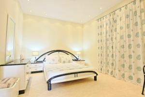 A bed or beds in a room at Acharavi Beach Villa by PosarelliVillas