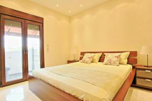 A bed or beds in a room at Acharavi Beach Villa by PosarelliVillas