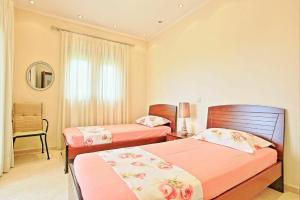 A bed or beds in a room at Acharavi Beach Villa by PosarelliVillas