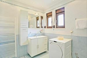 A bathroom at Acharavi Beach Villa by PosarelliVillas