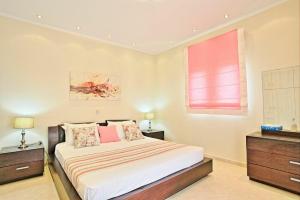 A bed or beds in a room at Acharavi Beach Villa by PosarelliVillas