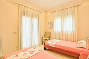 A bed or beds in a room at Acharavi Beach Villa by PosarelliVillas