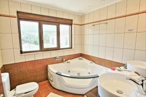 A bathroom at Acharavi Beach Villa by PosarelliVillas
