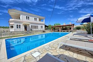 The swimming pool at or close to Acharavi Beach Villa by PosarelliVillas