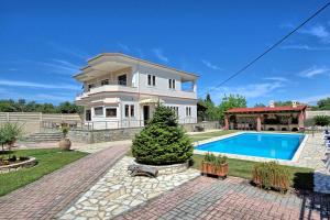 The swimming pool at or close to Acharavi Beach Villa by PosarelliVillas