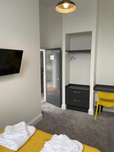 a room with a bedroom with a bed and a tv at Marylebone by Pureserviced in Plymouth