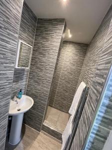 a bathroom with a sink and a shower at Marylebone by Pureserviced in Plymouth